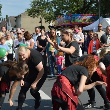 Tanzgruppe f&uuml;hrt eine Auff&uuml;hrung vor Publikum auf einer Stra&szlig;enveranstaltung durch.