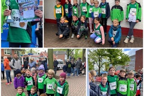 Kinder in gr&uuml;nen Shirts pr&auml;sentieren Pokale und Urkunden vom Stadtlauf, Gruppenfotos bei der Veranstaltung.