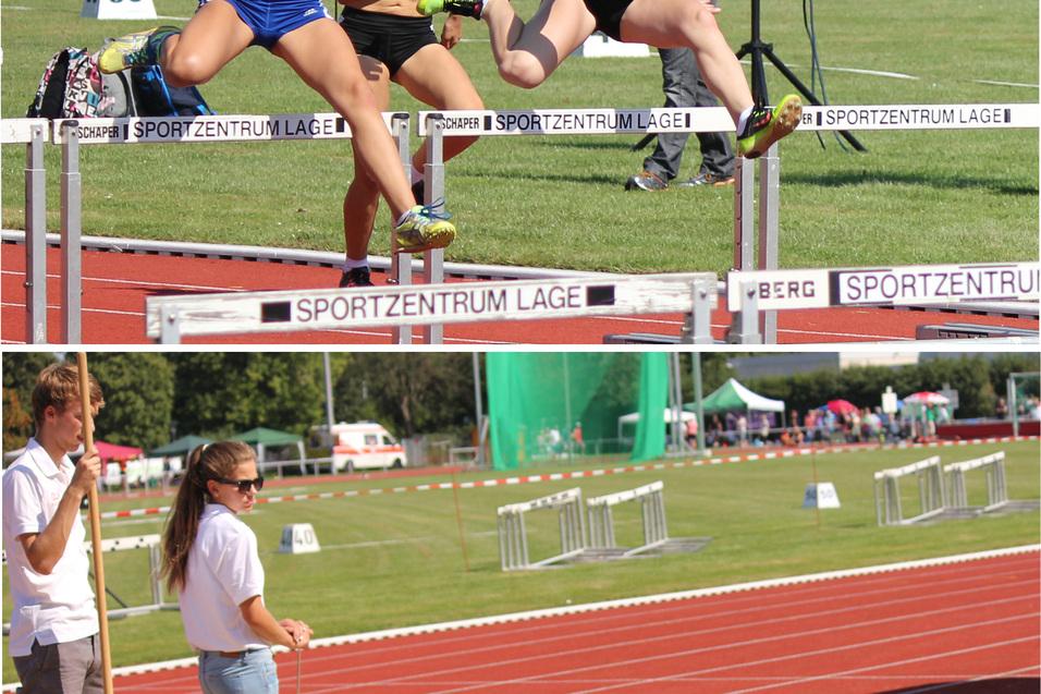 Zwei Wettbewerberinnen springen &uuml;ber Hindernisse bei einem Leichtathletik-Event, w&auml;hrend eine Athletin in eine Sandschicht springt.