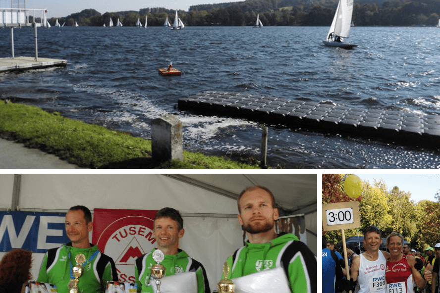 Drei Männer in Sportkleidung halten Pokale und Flaschen in einem Zelt, im Hintergrund eine Wettkampfbanner.