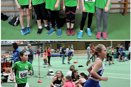 Sechs junge Leichtathletinnen in grünen Trikots stehen nebeneinander, darunter eine Läuferin in Aktion auf der Bahn.