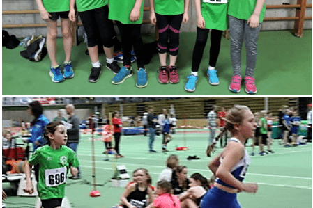 Sechs junge Leichtathletinnen in gr&uuml;nen Trikots stehen nebeneinander, darunter eine L&auml;uferin in Aktion auf der Bahn.