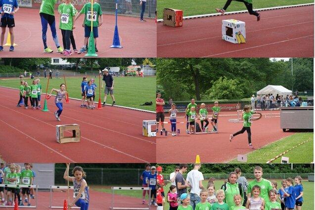 Kindersportveranstaltung mit mehreren Stationen und Teilnehmern in gr&uuml;nen Trikots auf einem Leichtathletikfeld.
